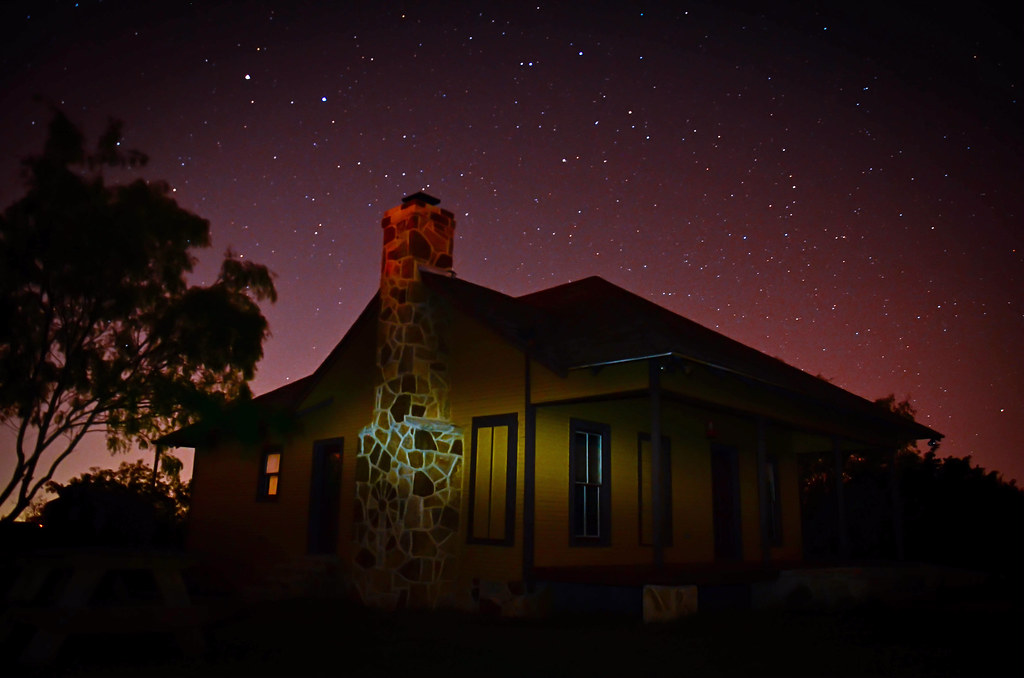 The historic farmhouse beneath a clear, star-filled night sky