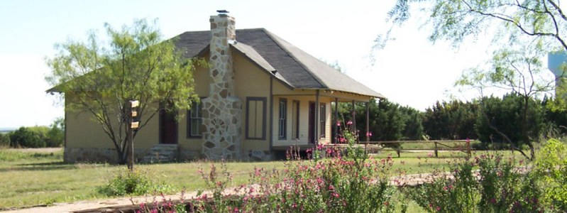 The historic farmhouse and garden in daylight